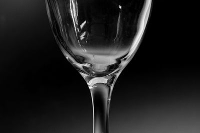 Close-up of beer glass against black background