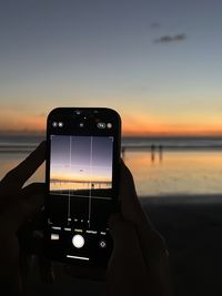 Cropped hand of person using mobile phone