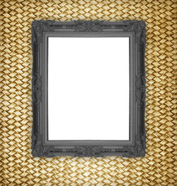 Close-up of blank picture frame on designed wall