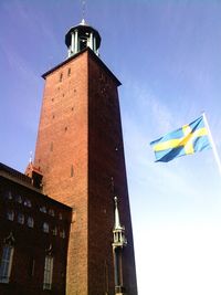 Low angle view of clock tower against blue sky