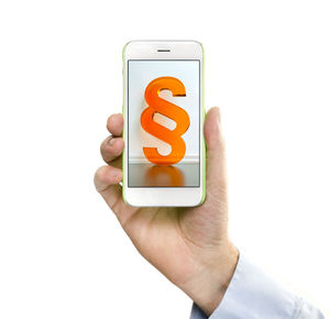 Close-up of hand holding smart phone over white background