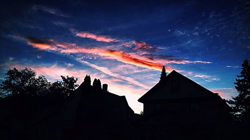 Low angle view of silhouette trees against sky at sunset