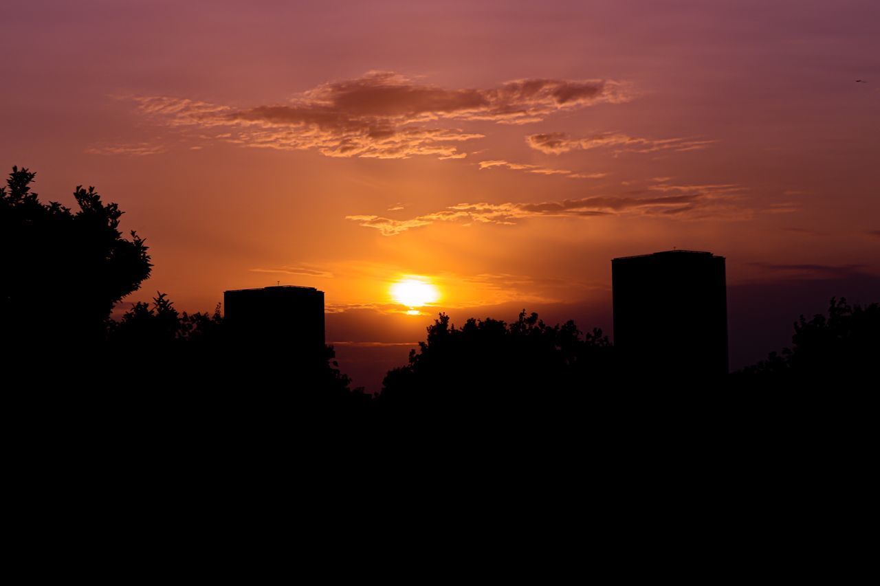 SILHOUETTE BUILDINGS AGAINST ORANGE SKY