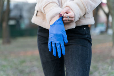 Midsection of woman holding umbrella