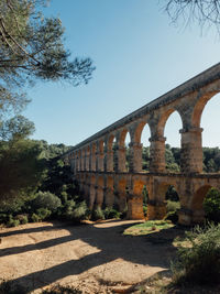 Arch bridge against clear sky