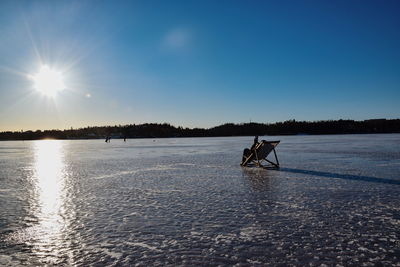 Scenic view of frozen lake against sky during winter