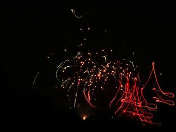 Low angle view of firework display against sky at night