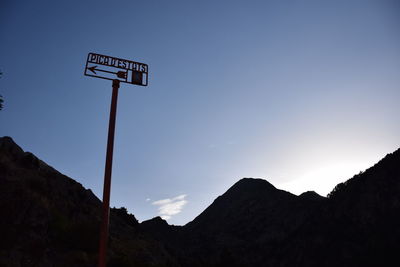 Low angle view of road sign against clear sky