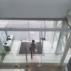 High angle view of man walking at doorway