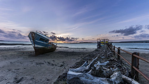 Scenic view of beach against sky during sunset