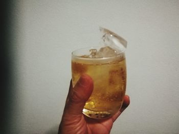 Close-up of hand holding glass of wine