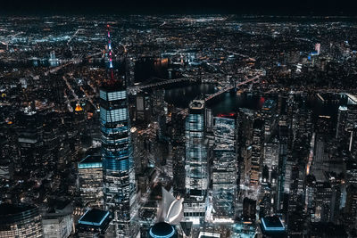 High angle view of city lit up at night