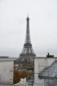 Tower in city against sky