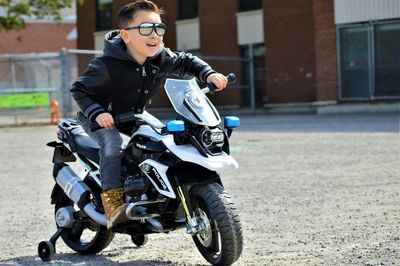 Boy riding toy bike on road