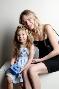 Portrait of young woman sitting at home