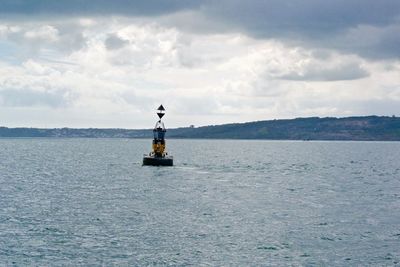 Boat sailing in sea against sky