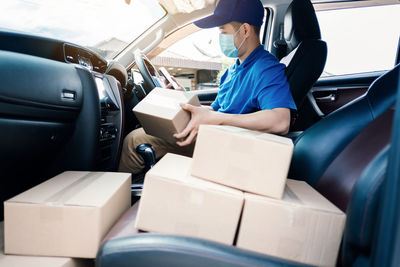 Rear view of man sitting in car