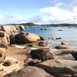 Rocks on beach against sky