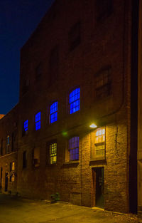 Illuminated building against sky at night