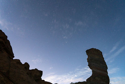 Low angle view of rock formation against sky