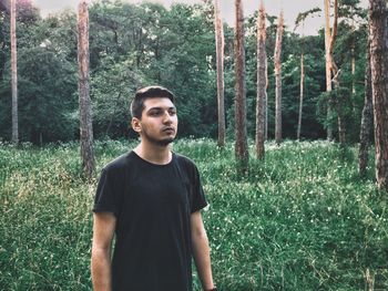 Young man standing in forest