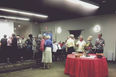 People standing in illuminated room