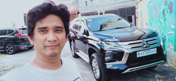 Portrait of man in car on street