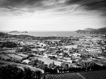 High angle view of townscape by sea against sky