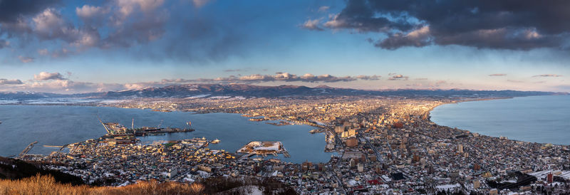 High angle view of city by sea during winter