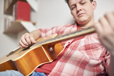 Midsection of man playing piano