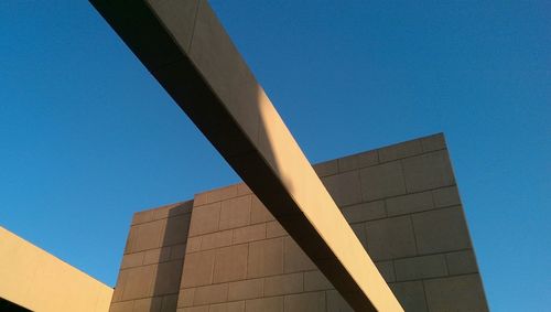 Low angle view of building against clear blue sky
