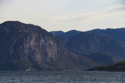 Scenic view of sea and mountains against sky