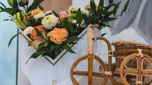 Flower vase on table against wall