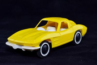 Close-up of yellow toy car on black background