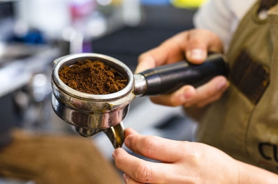 Close-up of hand holding coffee cup