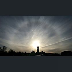 Silhouette of building against sunset sky