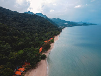 High angle view of sea and mountains against sky