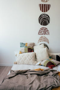 Cozy bed in a hipster bedroom. detailed interior of the room with pillows and textiles on the bed.