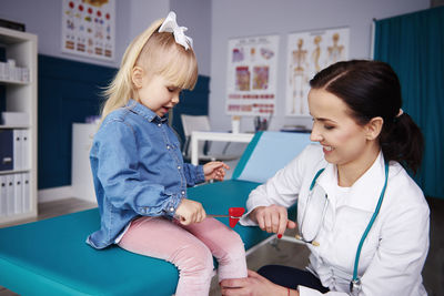 Doctor examining girl in medical practice