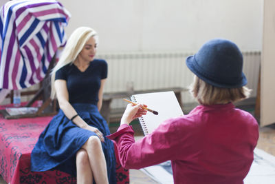 Rear view of woman sitting with text