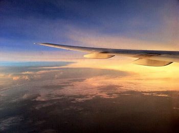 Cropped image of airplane flying over landscape