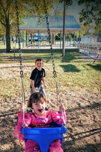 Siblings enjoying at park