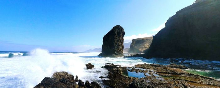 Panoramic view of sea against clear blue sky