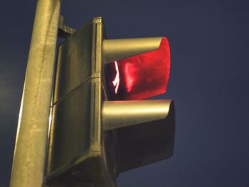 Low angle view of road signal against sky