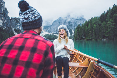 Full length of friends in lake during winter