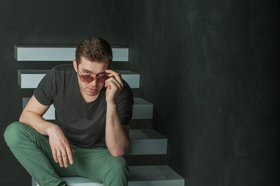 Portrait of young man sitting at home