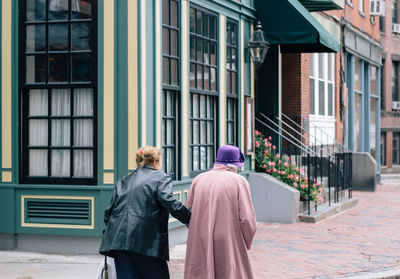 Rear view of people walking in city