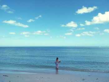 Man standing on beach against sky