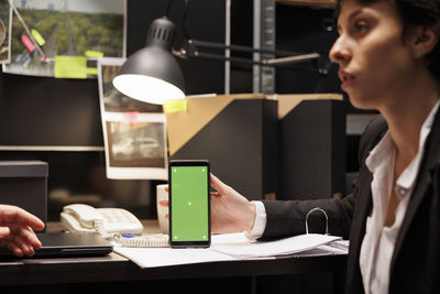 Businesswoman using mobile phone at office