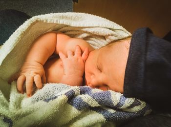 Close-up of baby sleeping on bed